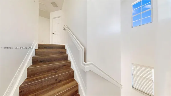 a view of a bathroom with a glass door and a bathroom