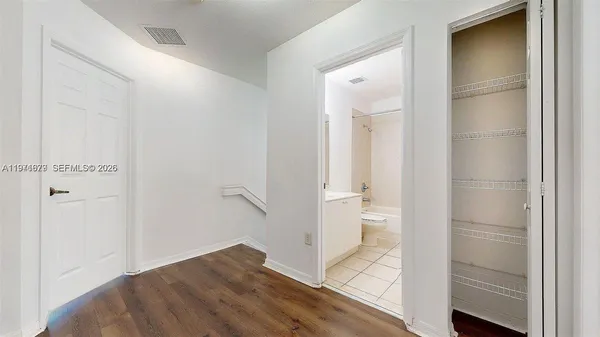 a view of a room with wooden floor