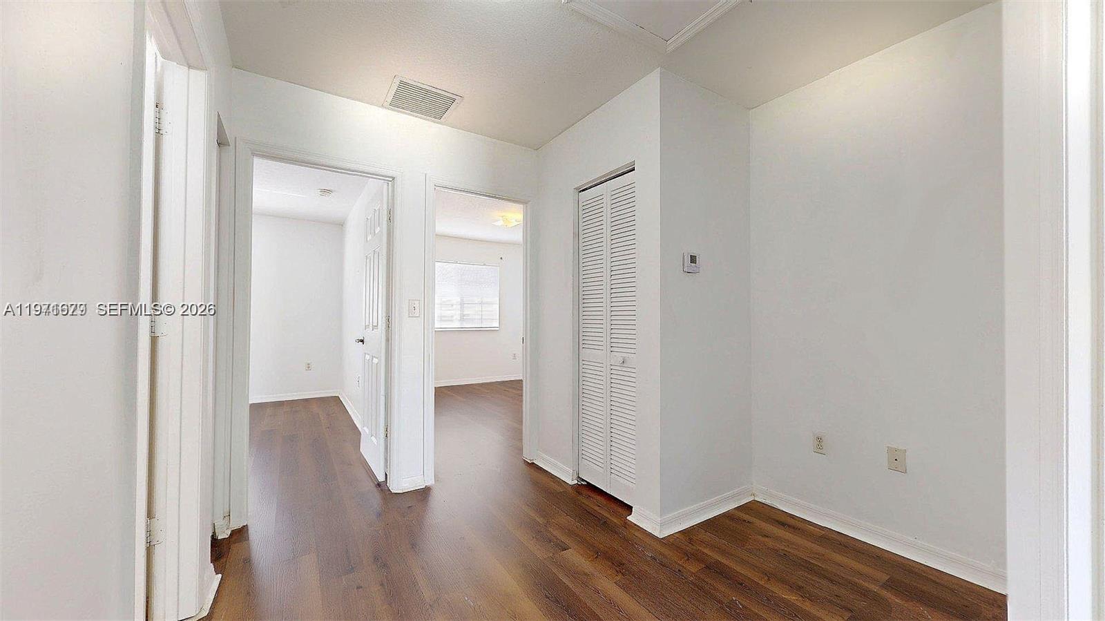 14162 Southwest 260th Street, Unit 104 Homestead, FL 33032 - Photo 22 of 35 a view of a room with wooden floor