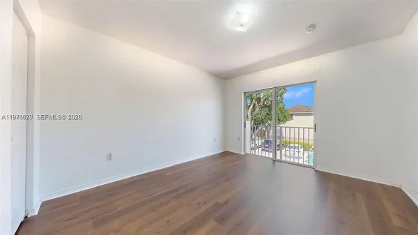 a view of room with wooden floor