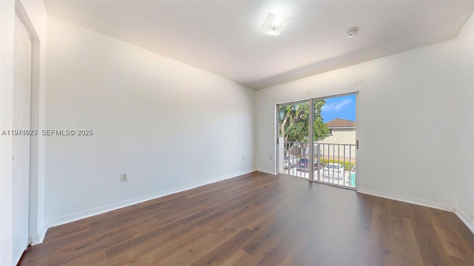 14162 Southwest 260th Street, Unit 104 Homestead, FL 33032 - Photo 23 of 35 wooden floor in a hall with an entryway