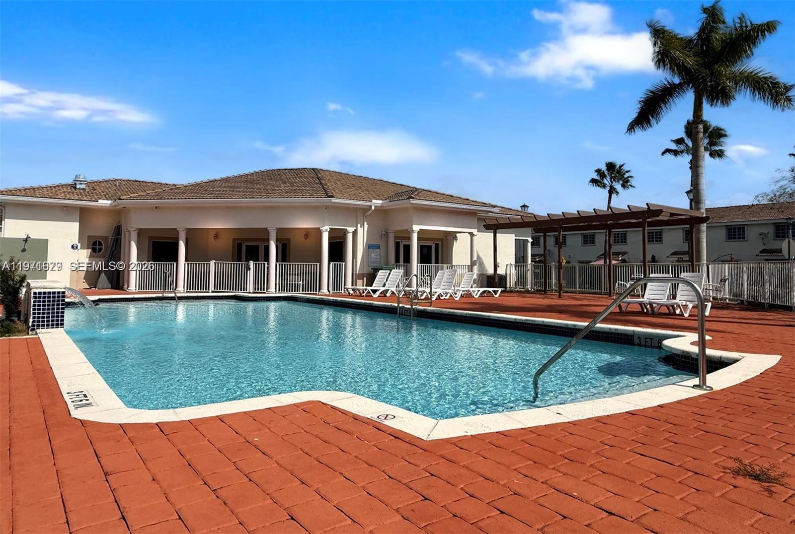 14162 Southwest 260th Street, Unit 104 Homestead, FL 33032 - Photo 4 of 35 a view of a house with swimming pool