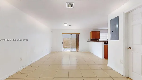a view of a kitchen with an empty space and a window