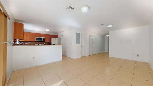 a kitchen with stainless steel appliances granite countertop a sink and a refrigerator