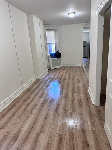 a view of a room with wooden floor