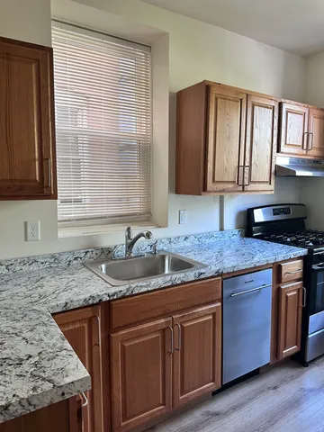 a kitchen with granite countertop cabinets sink and window