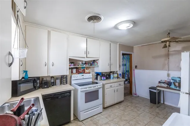 a kitchen with a sink cabinets and appliances