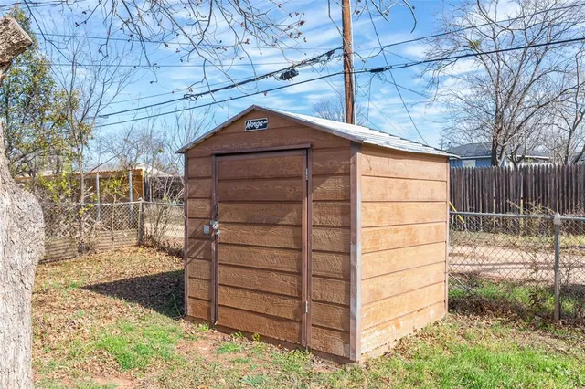 a backyard of a house with table and chairs