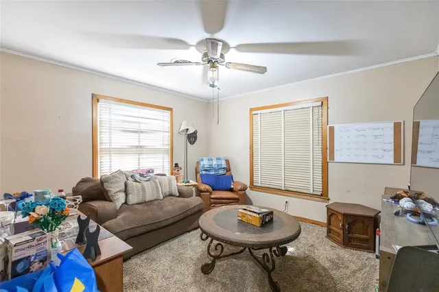 a living room with furniture a chandelier and a window