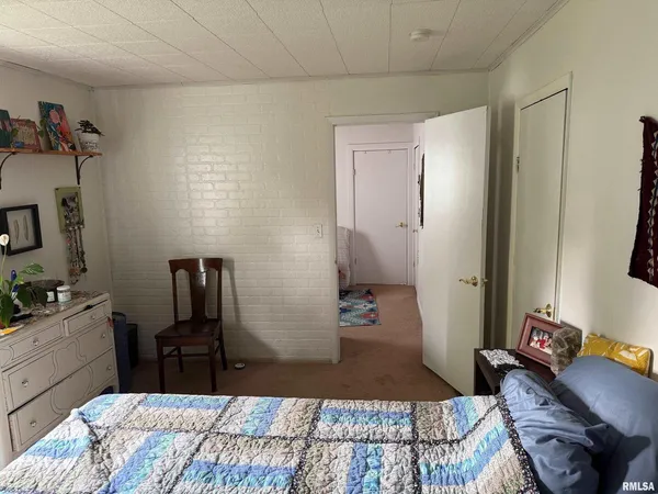 a bedroom with a bed and a flat tv screen