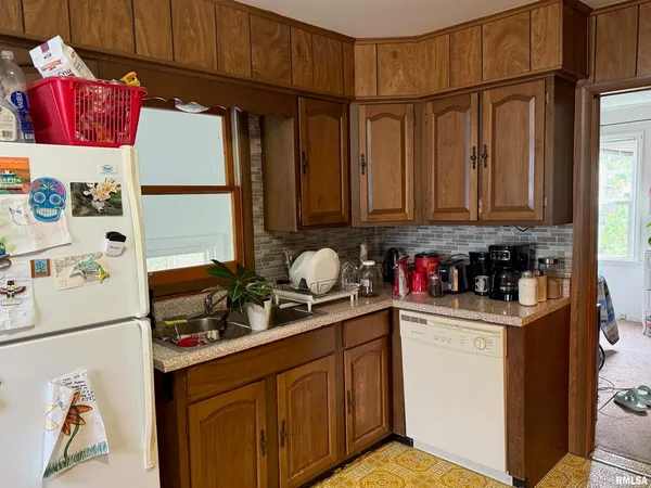 a kitchen with stainless steel appliances granite countertop a refrigerator and a stove