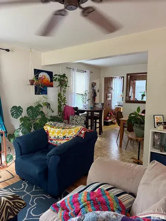 a living room with furniture and a dining table