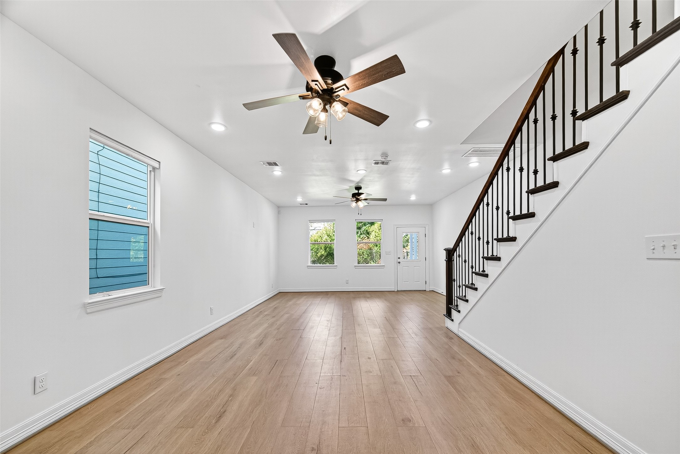 716 Zoe Street Houston, TX 77020 - Photo 13 of 39 a view of wooden floor and a chandelier fan in a room