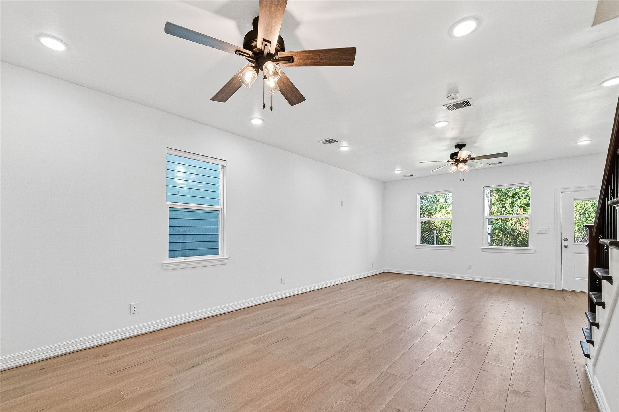 716 Zoe Street Houston, TX 77020 - Photo 14 of 39 a view of an empty room with wooden floor and a window