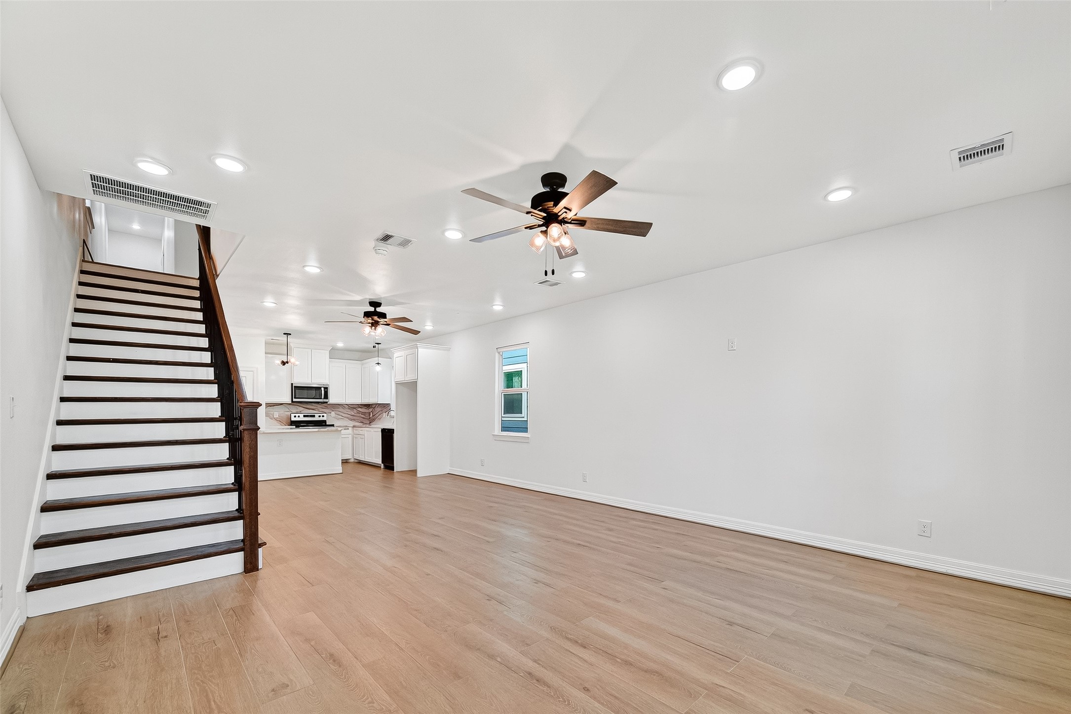 716 Zoe Street Houston, TX 77020 - Photo 18 of 39 wooden floor in an empty room with a window