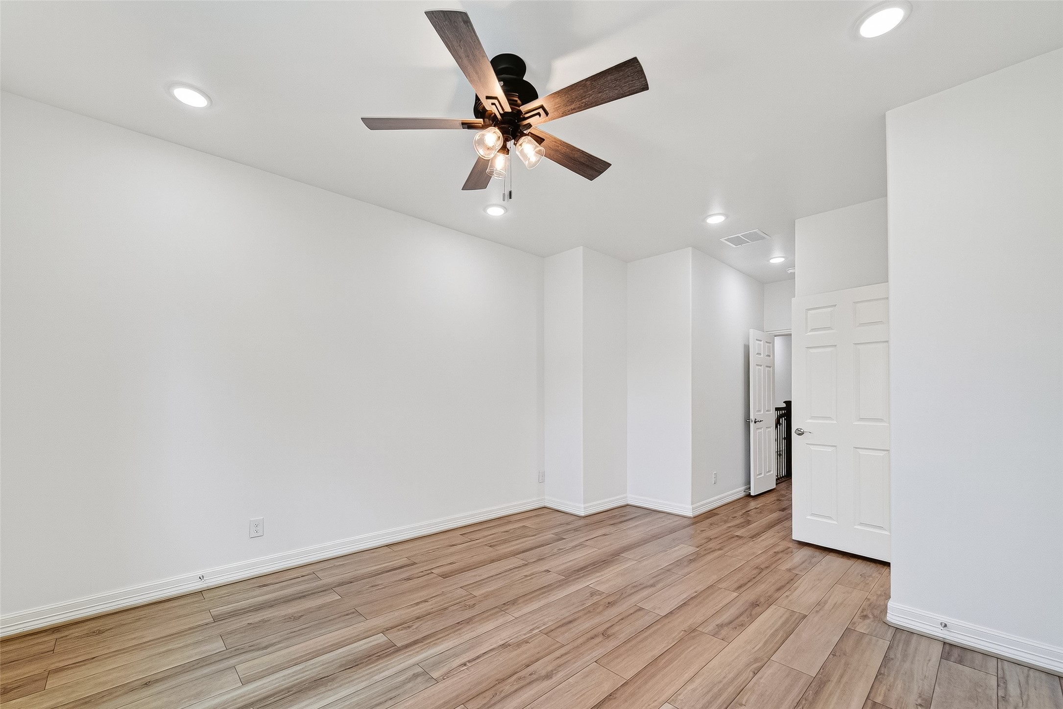 716 Zoe Street Houston, TX 77020 - Photo 22 of 39 an empty room with wooden floor and a ceiling fan