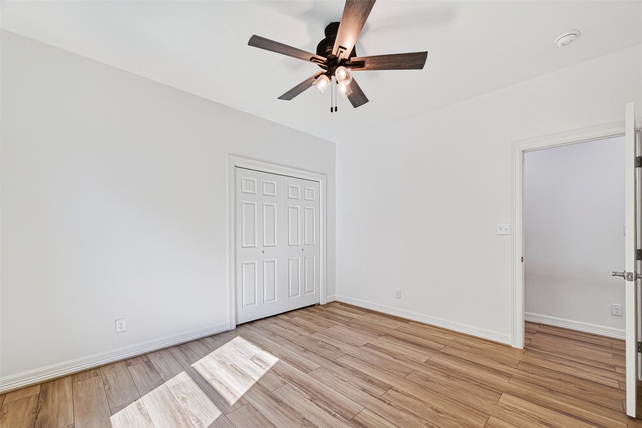 716 Zoe Street Houston, TX 77020 - Photo 35 of 39 an empty room with wooden floor fan and windows
