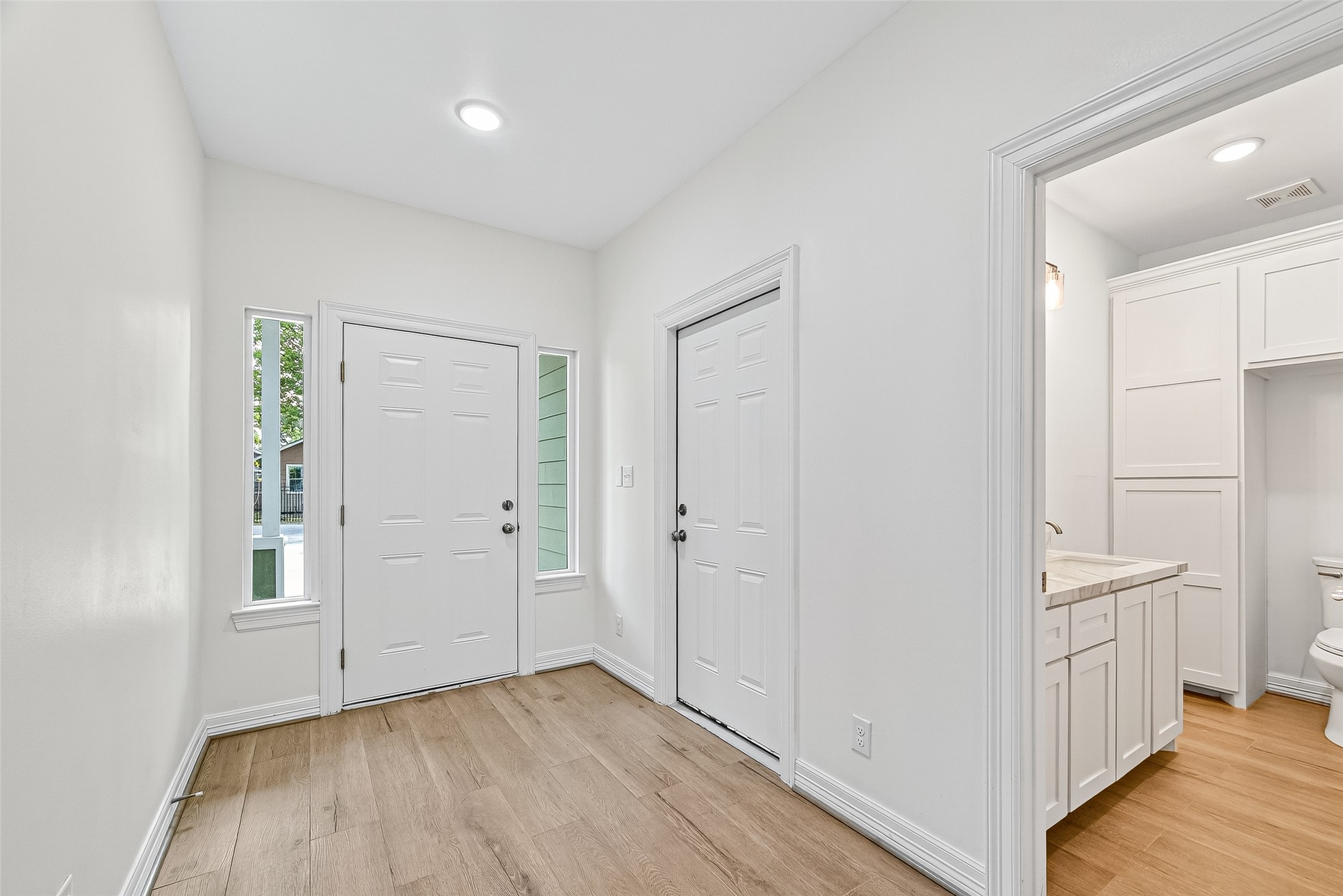 716 Zoe Street Houston, TX 77020 - Photo 5 of 39 a view of empty room with wooden floor and cabinet