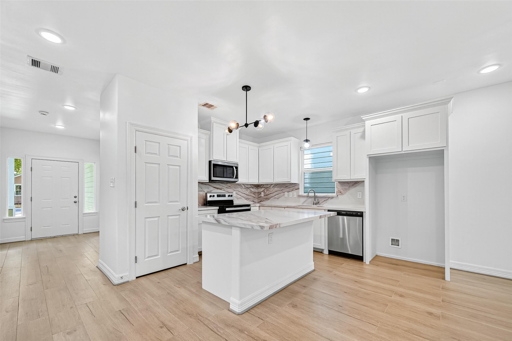 716 Zoe Street Houston, TX 77020 - Photo 8 of 39 a kitchen with white cabinets and stainless steel appliances