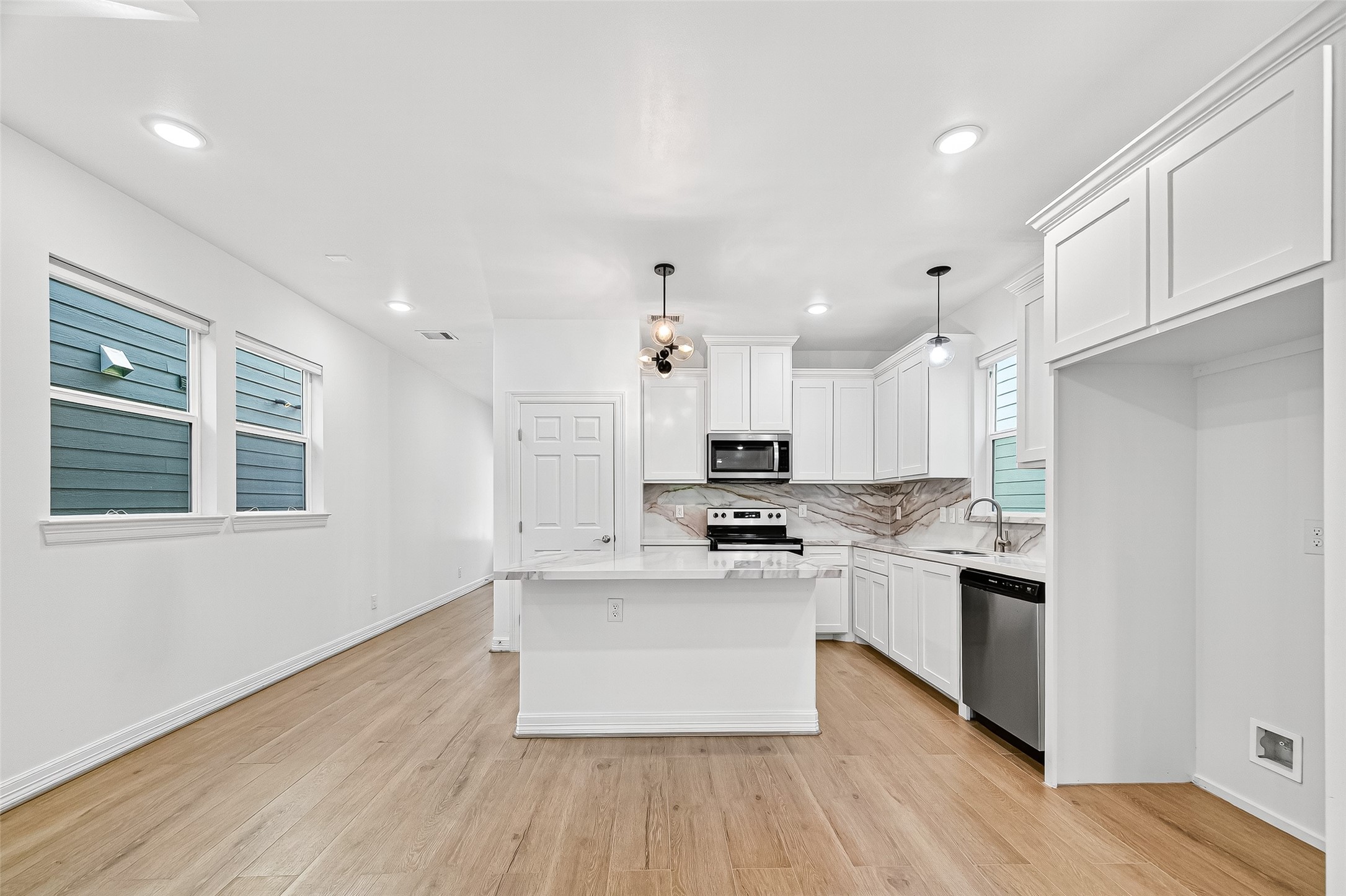 716 Zoe Street Houston, TX 77020 - Photo 10 of 39 a kitchen with stainless steel appliances a stove top oven a sink dishwasher and a refrigerator with wooden floor