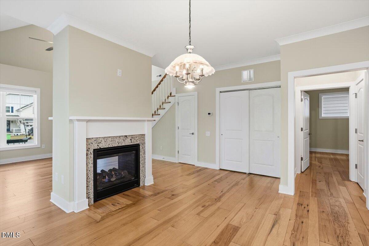 4409 Spiedie Court Raleigh, NC 27606 - Photo 11 of 33 a view of an empty room with wooden floor fireplace and a window