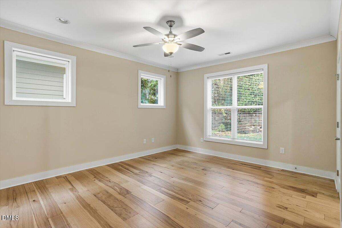 4409 Spiedie Court Raleigh, NC 27606 - Photo 15 of 33 a view of an empty room with wooden floor and a window