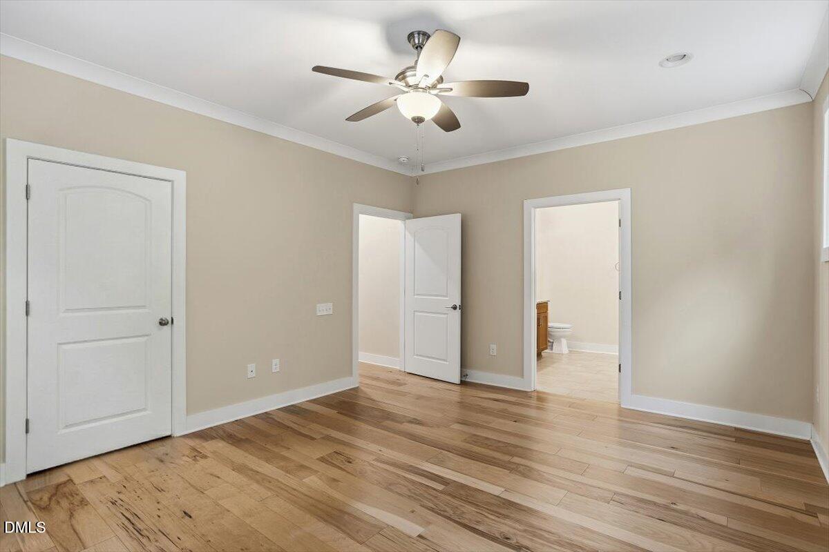 4409 Spiedie Court Raleigh, NC 27606 - Photo 16 of 33 a view of an empty room with wooden floor