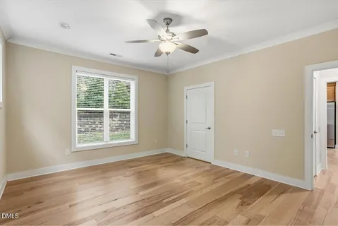 a view of an empty room with wooden floor