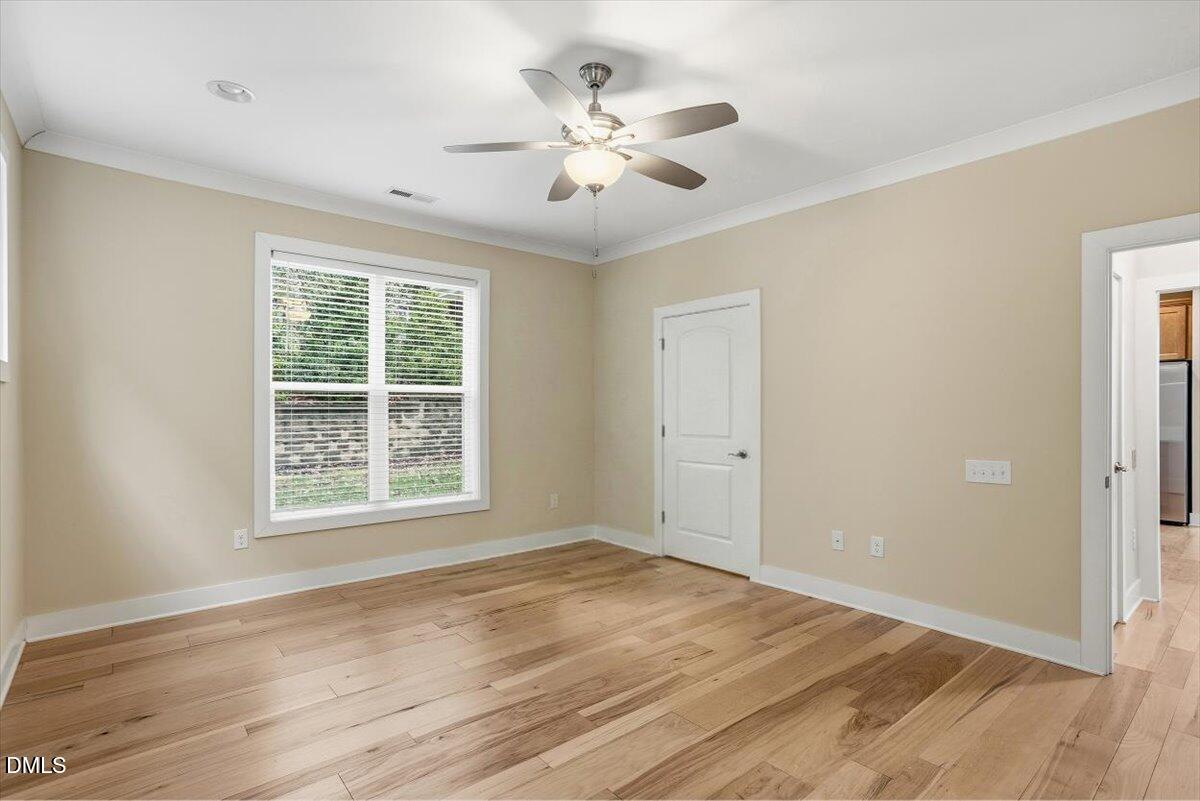 4409 Spiedie Court Raleigh, NC 27606 - Photo 17 of 33 an empty room with wooden floor and windows
