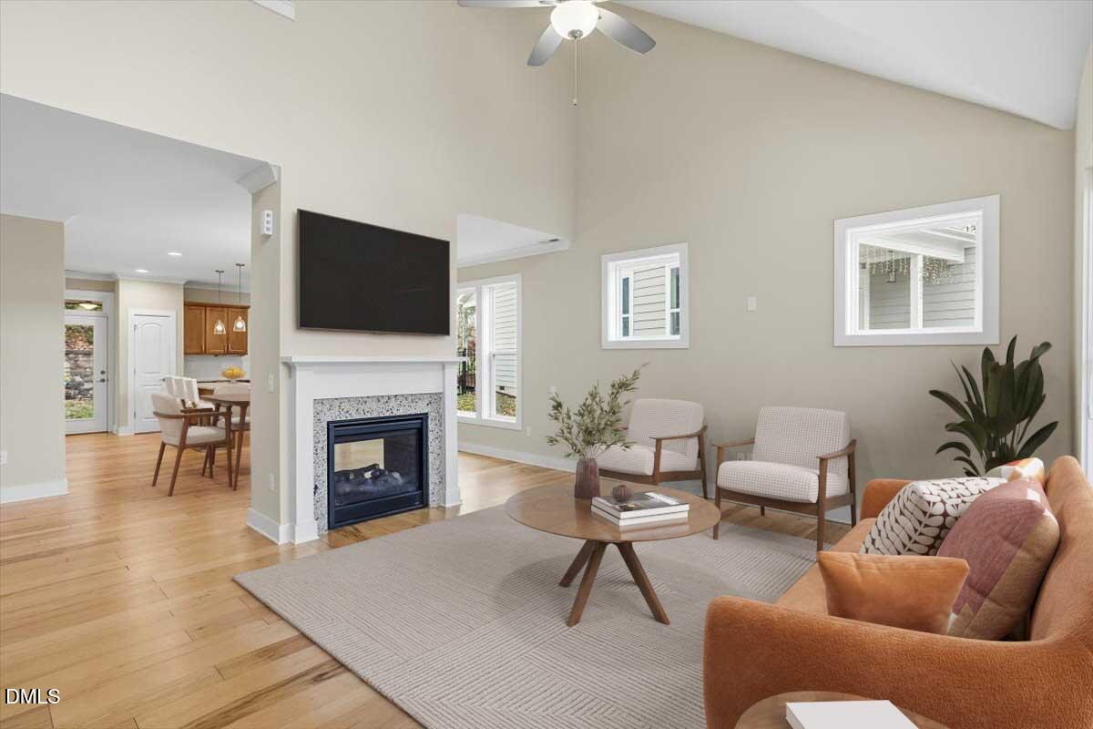 4409 Spiedie Court Raleigh, NC 27606 - Photo 2 of 33 a living room with furniture a fireplace and a flat screen tv