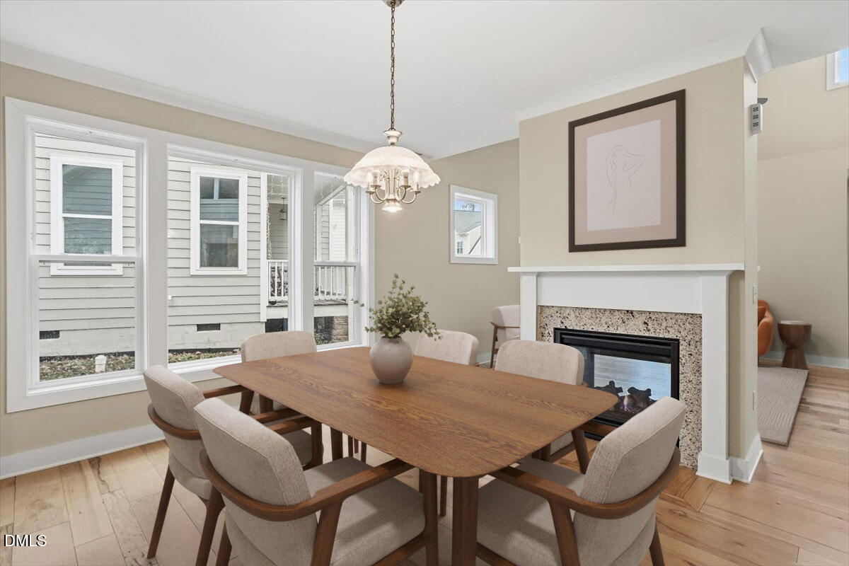 4409 Spiedie Court Raleigh, NC 27606 - Photo 3 of 33 a view of a dining room with furniture window and wooden floor