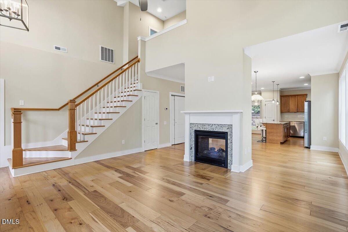 4409 Spiedie Court Raleigh, NC 27606 - Photo 8 of 33 a view of a livingroom with wooden floor and a fireplace