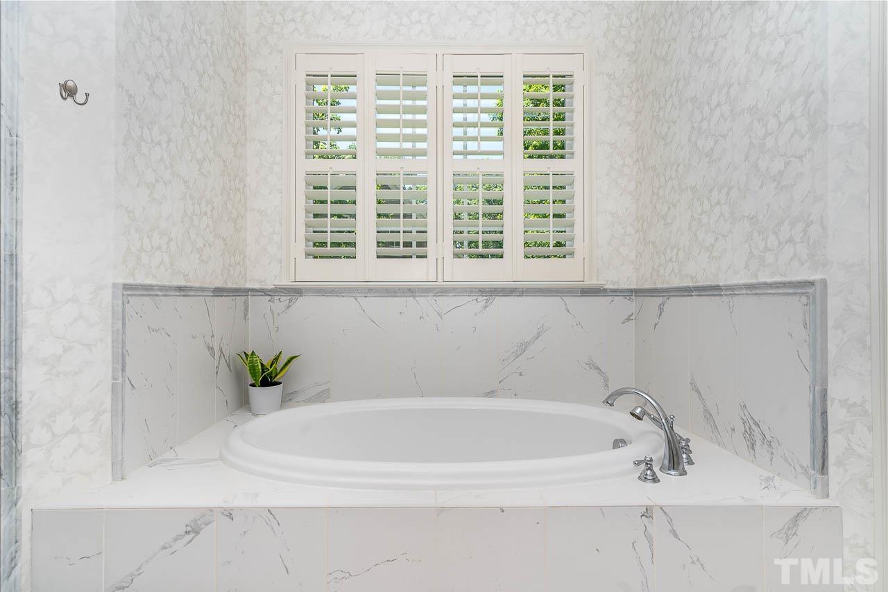 11308 Moonsprite Way Raleigh, NC 27614 - Photo 31 of 53 a white bath tub sitting next to a window