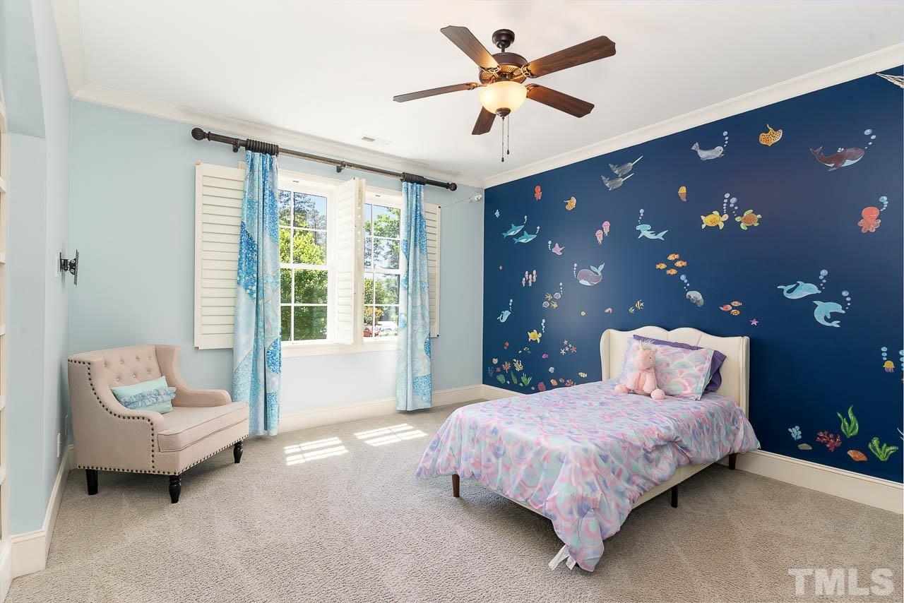 11308 Moonsprite Way Raleigh, NC 27614 - Photo 34 of 53 a bedroom with a large bed and a chandelier