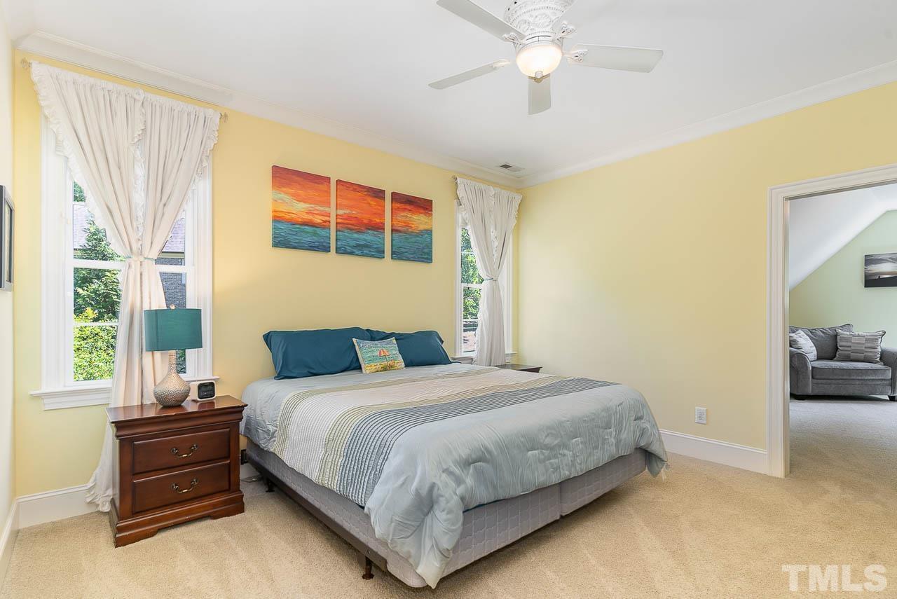 11308 Moonsprite Way Raleigh, NC 27614 - Photo 39 of 53 a bedroom with a bed and a chandelier