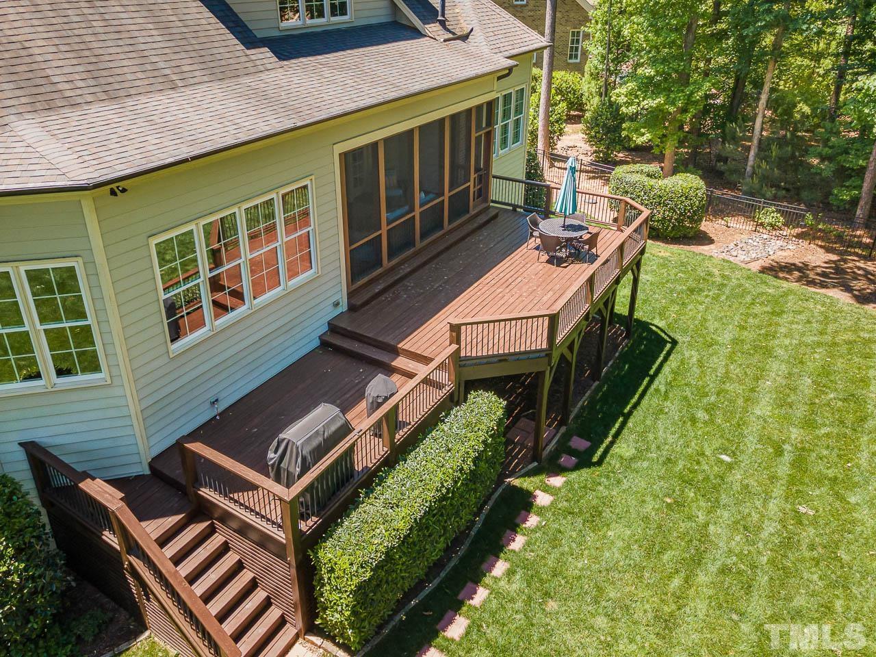 11308 Moonsprite Way Raleigh, NC 27614 - Photo 50 of 53 a view of a patio with table and chairs with wooden floor and fence