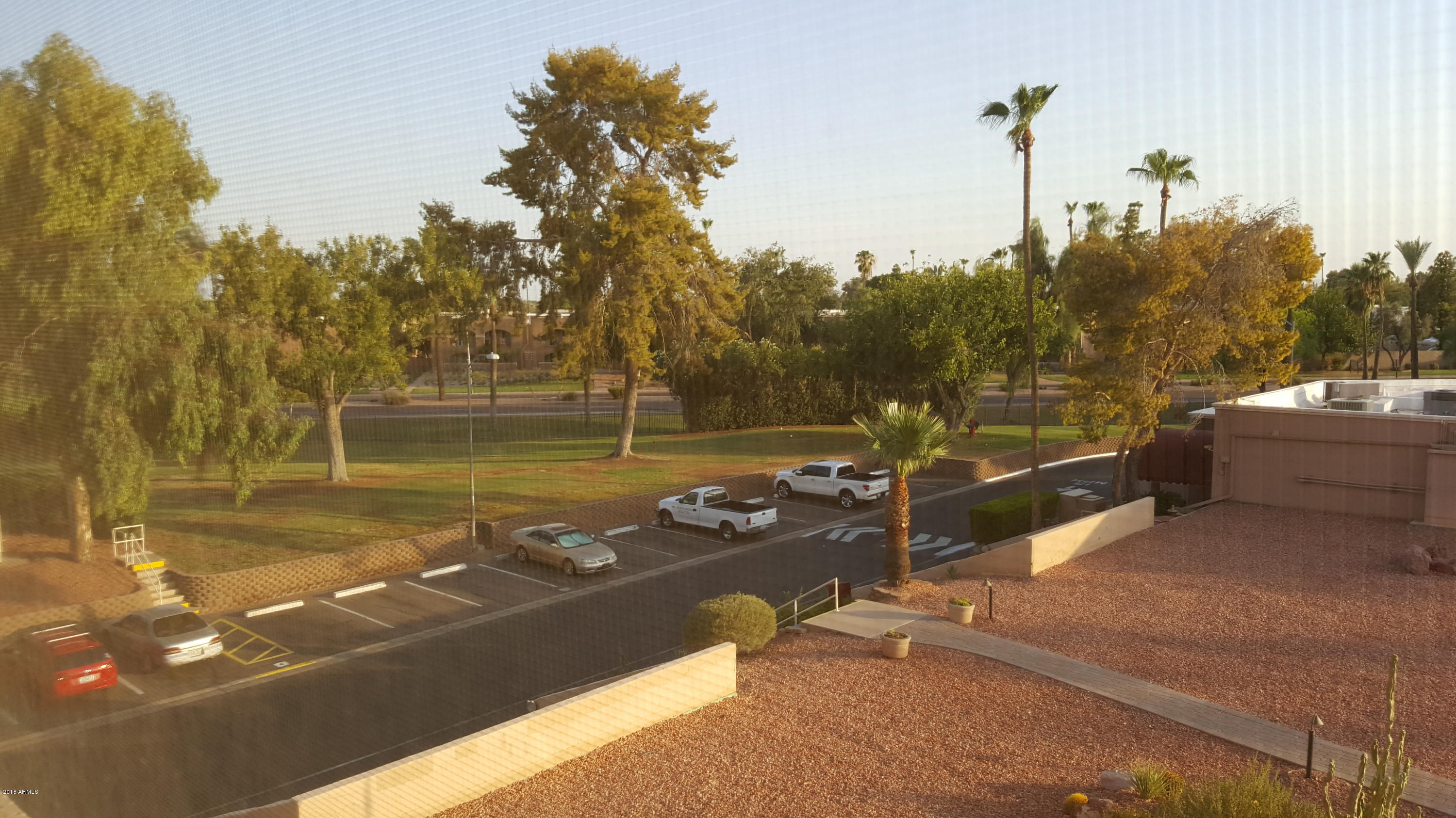 7820 East Camelback Road, Unit 310 Scottsdale, AZ 85251 - Photo 11 of 28 a view of a lake with a table and chairs