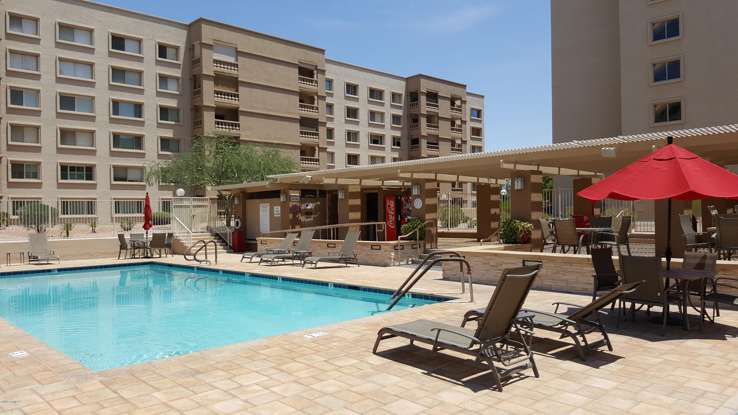 7820 East Camelback Road, Unit 310 Scottsdale, AZ 85251 - Photo 20 of 28 a view of a swimming pool with a table and chairs