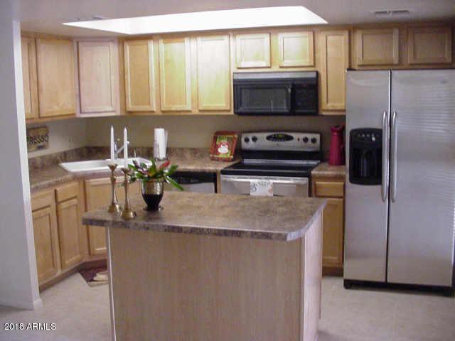 7820 East Camelback Road, Unit 310 Scottsdale, AZ 85251 - Photo 2 of 28 a kitchen with stainless steel appliances granite countertop a sink stove and refrigerator