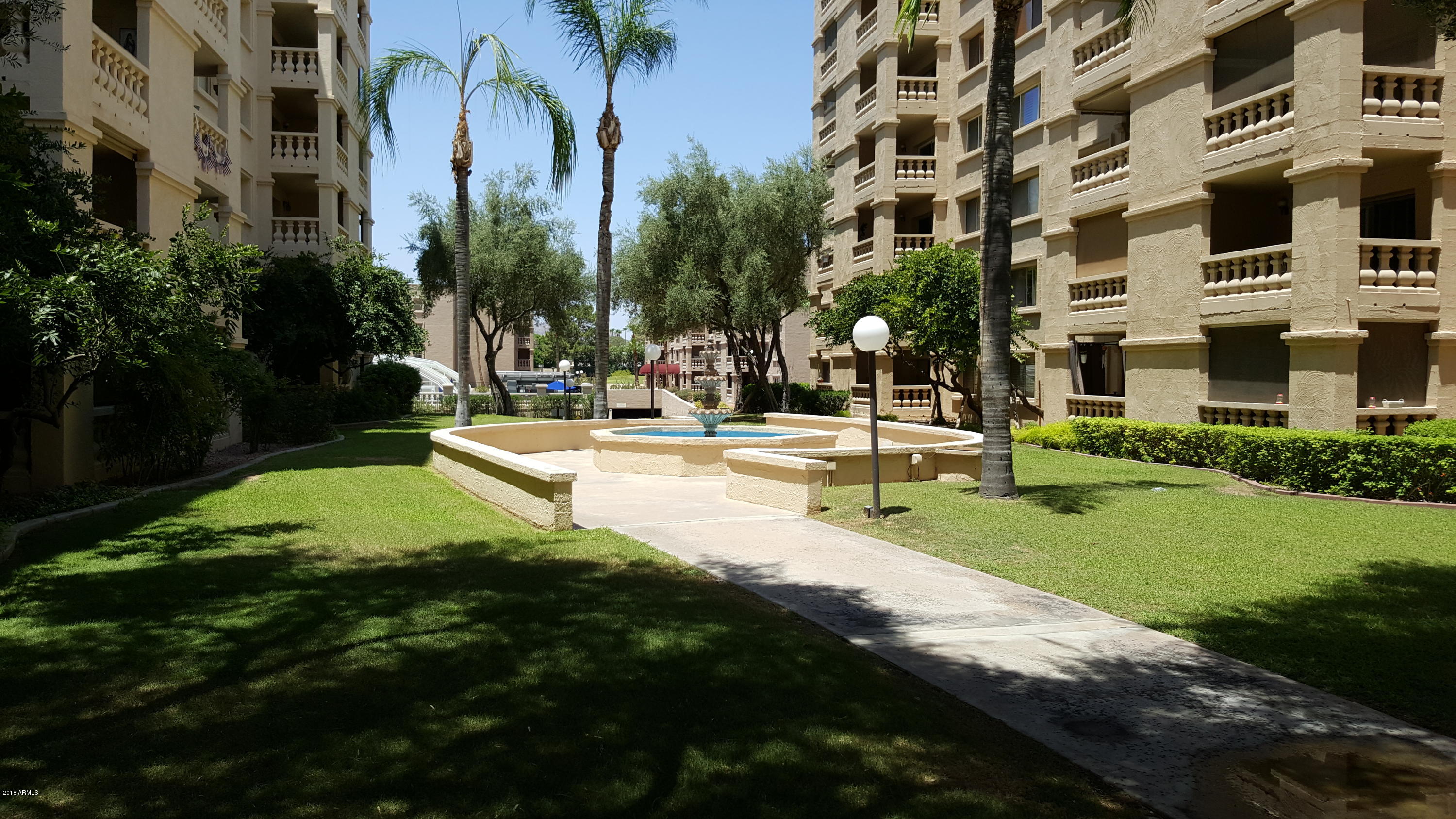 7820 East Camelback Road, Unit 310 Scottsdale, AZ 85251 - Photo 21 of 28 a view of a building with a yard