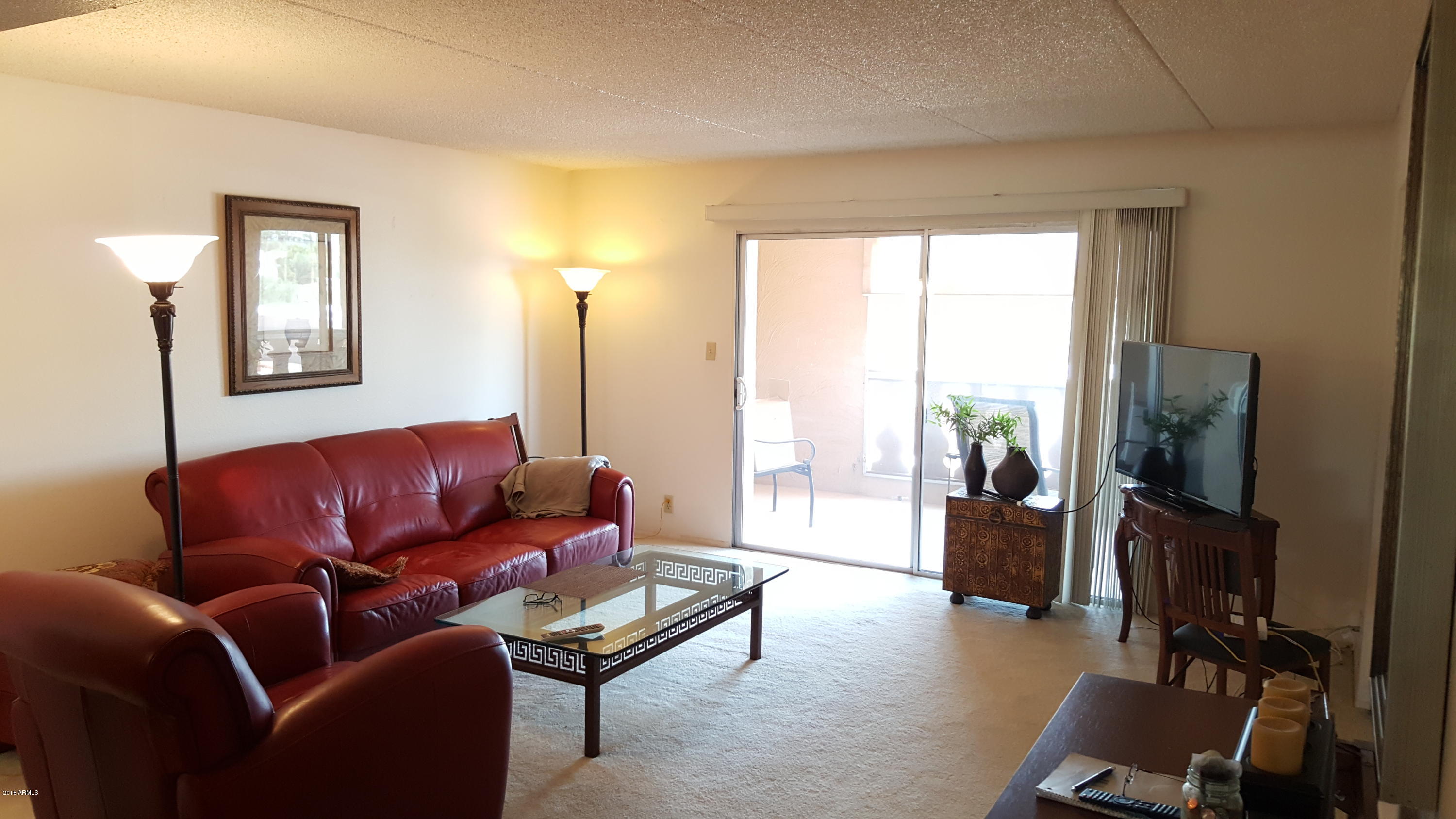 7820 East Camelback Road, Unit 310 Scottsdale, AZ 85251 - Photo 4 of 28 a living room with furniture and a flat screen tv