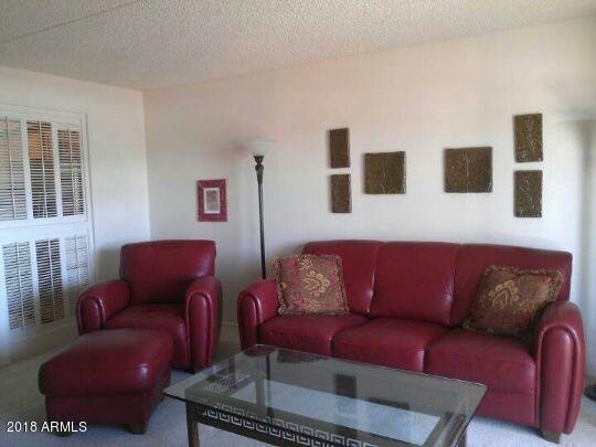 7820 East Camelback Road, Unit 310 Scottsdale, AZ 85251 - Photo 5 of 28 a living room with furniture and a couch