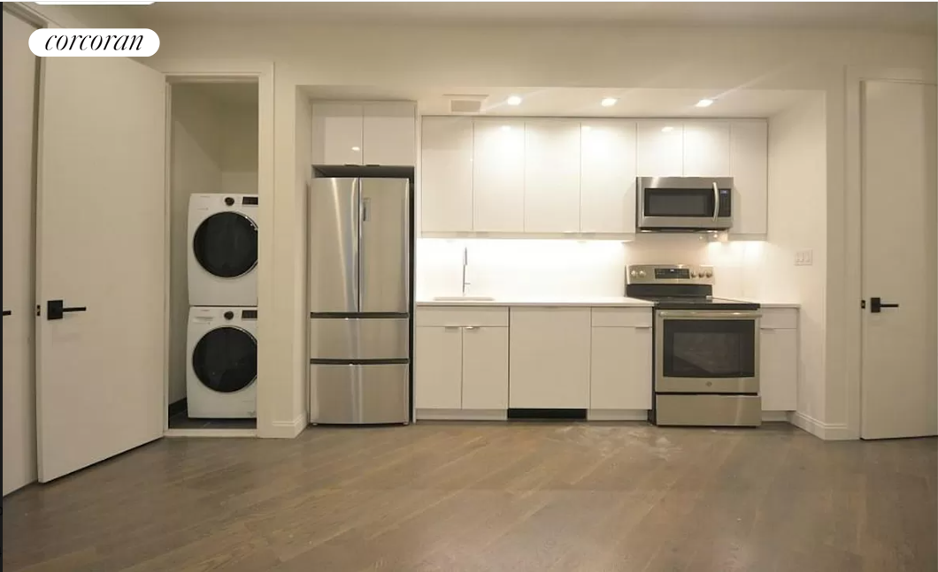 a view of kitchen appliances and cabinets