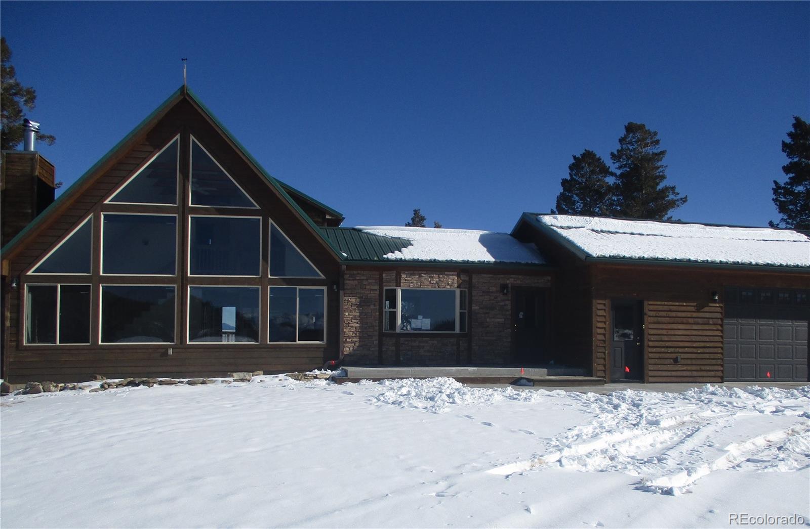490 Blacksmith Road Hartsel, CO 80449 - Photo 1 of 12 a front view of a house with a yard