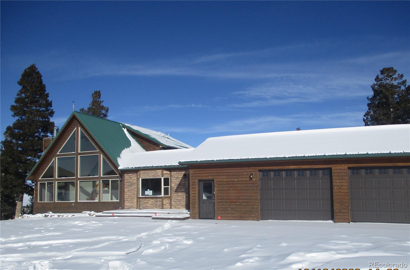 490 Blacksmith Road Hartsel, CO 80449 - Photo 2 of 12 a front view of a house with a garage