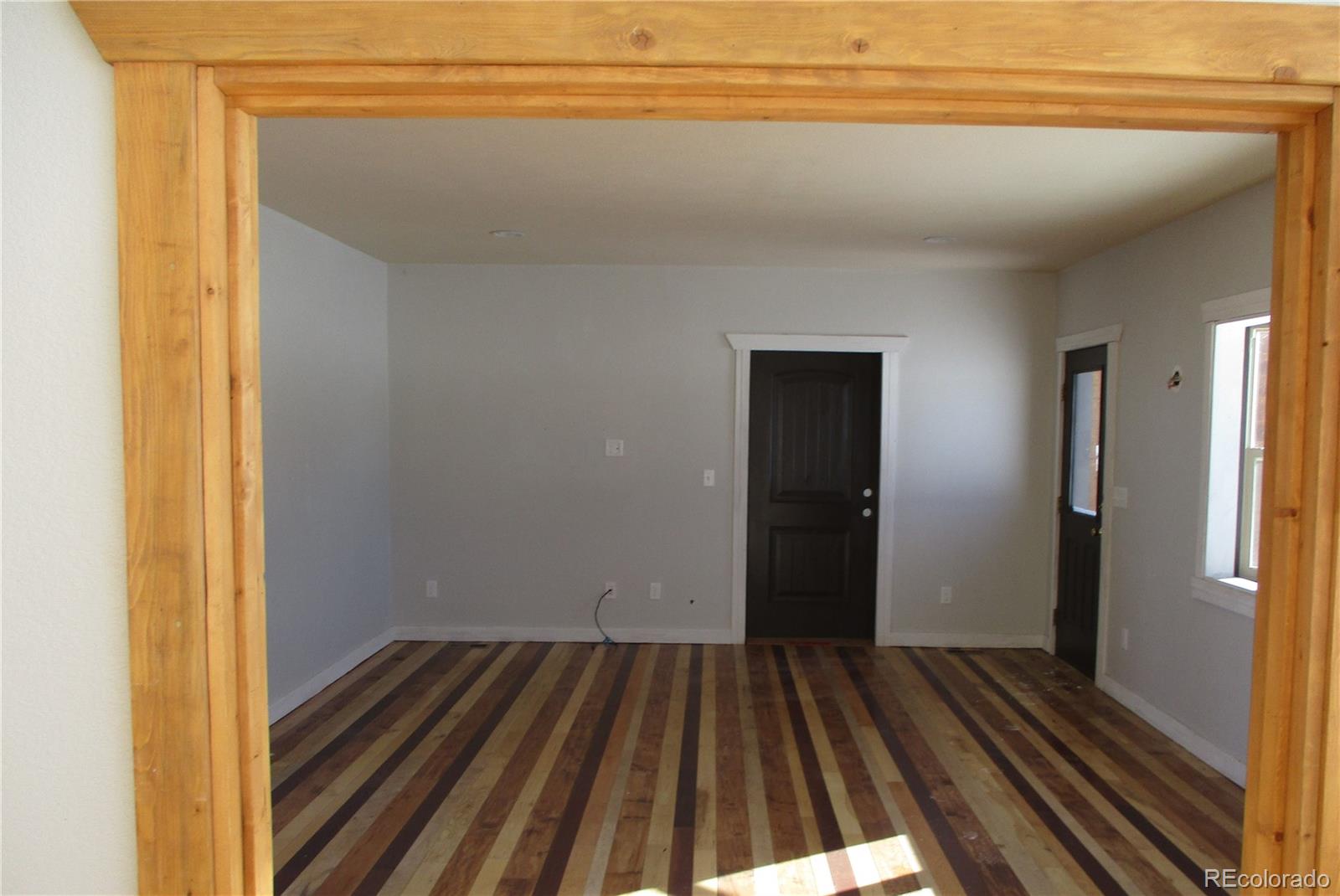490 Blacksmith Road Hartsel, CO 80449 - Photo 3 of 12 a view of a room with wooden floor and staircase