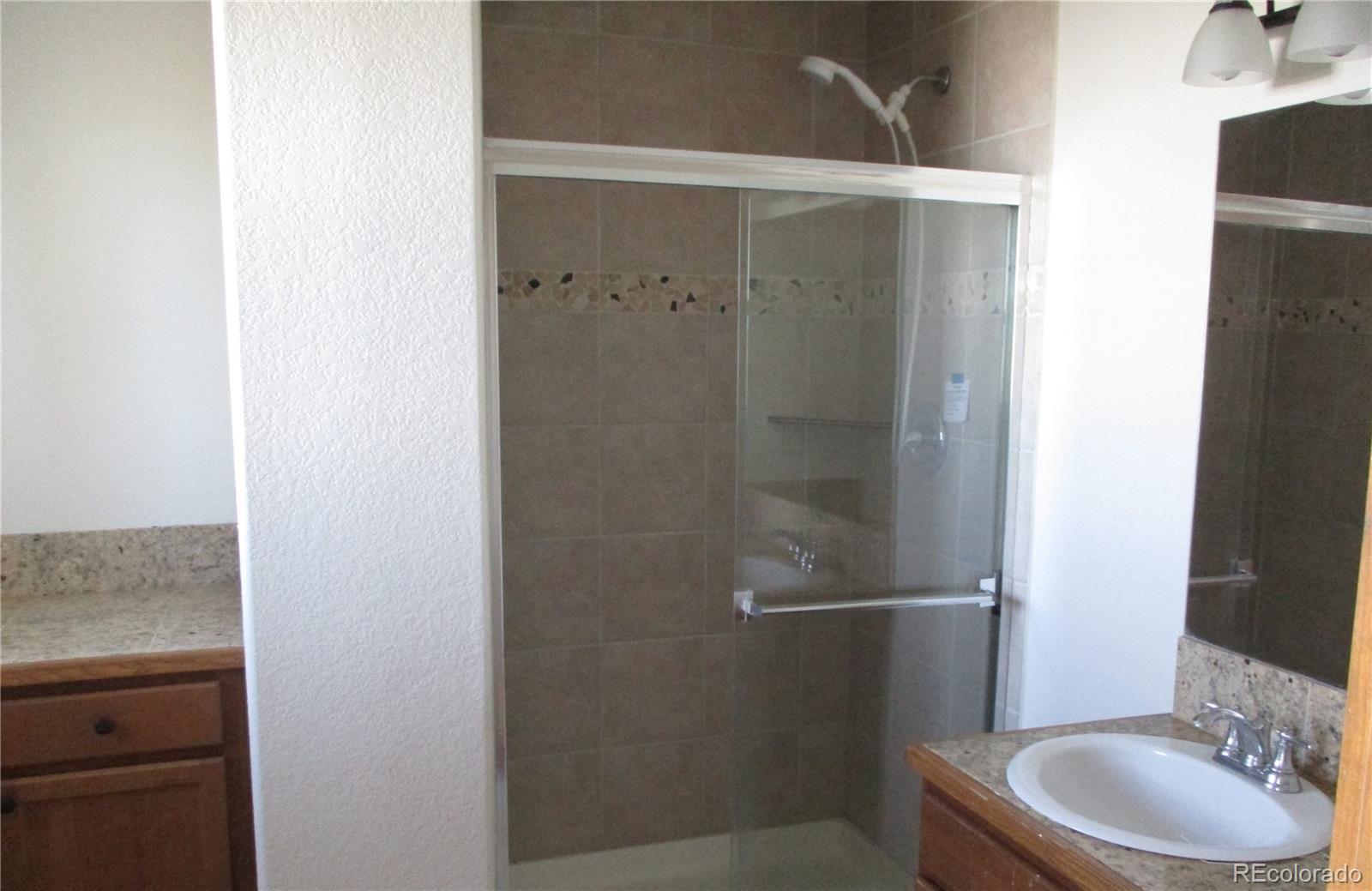 490 Blacksmith Road Hartsel, CO 80449 - Photo 8 of 12 a bathroom with a granite countertop sink toilet and shower