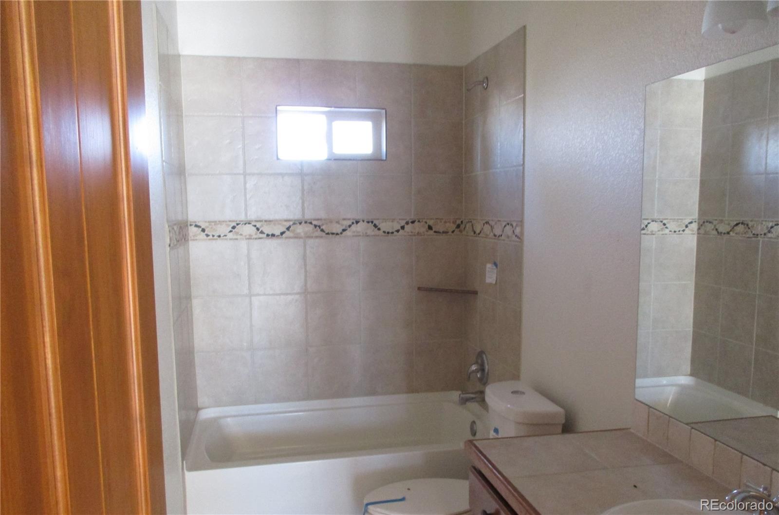 490 Blacksmith Road Hartsel, CO 80449 - Photo 9 of 12 a bathroom with a granite countertop bathtub shower and toilet