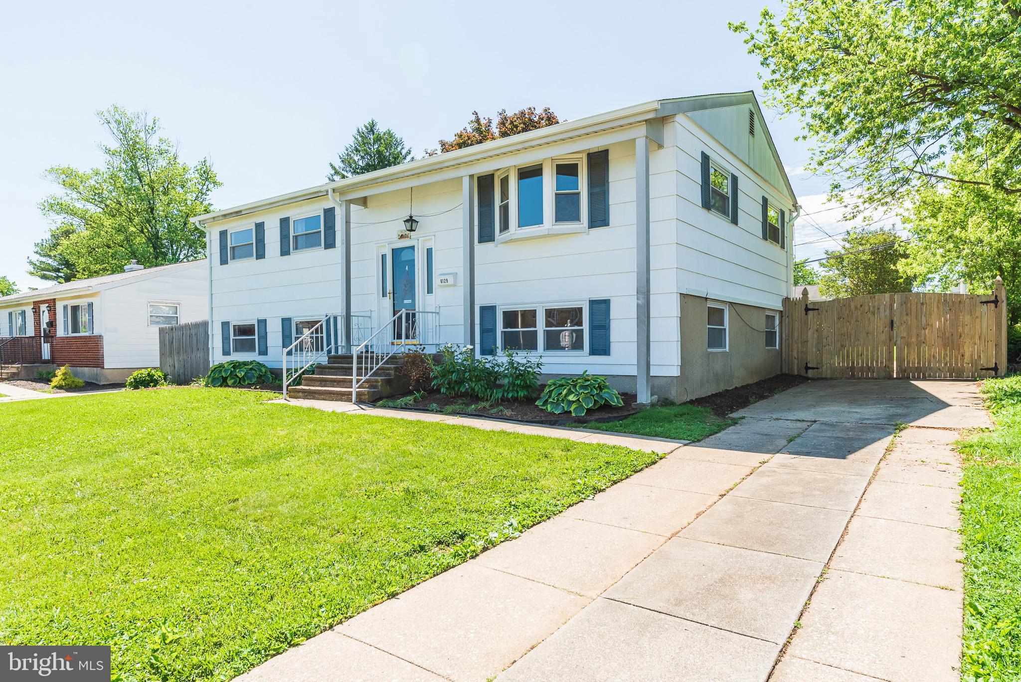 6129 Wheatland Road Baltimore, MD 21228 - Photo 2 of 48 a front view of a house with garden