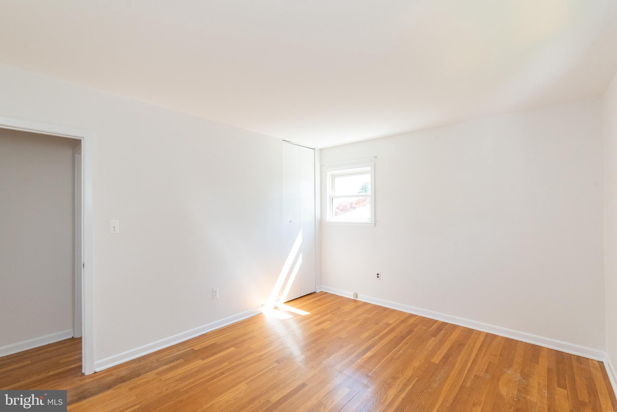 6129 Wheatland Road Baltimore, MD 21228 - Photo 15 of 48 an empty room with wooden floor and white walls